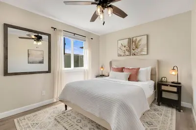 a bedroom with a bed and a ceiling fan at Downtown Windsor Home with Hot Tub and Pool Table in Windsor