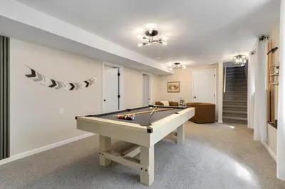 a living room with a pool table in it at Downtown Windsor Home with Hot Tub and Pool Table in Windsor