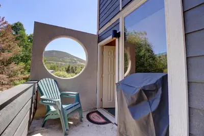 a patio with a chair and a round window at Orofino Dillon 104 condo in Dillon