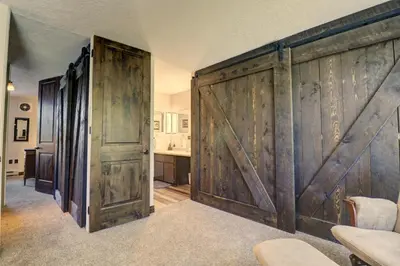 a sliding barn door in a room with a kitchen at Orofino Dillon 104 condo in Dillon