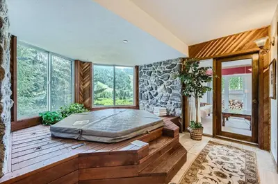 a bedroom with a bed in a room with windows at 122 Cinnamon Ridge condo in Keystone
