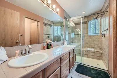 a bathroom with two sinks and a shower at 122 Cinnamon Ridge condo in Keystone