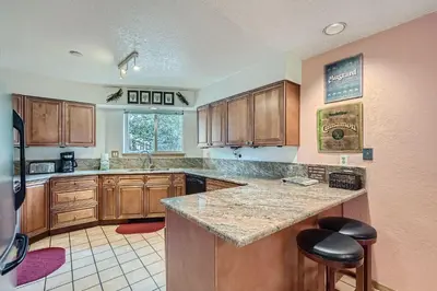 a kitchen with wooden cabinets and a counter top at 122 Cinnamon Ridge condo in Keystone