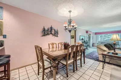 a dining room with a table and chairs at 122 Cinnamon Ridge condo in Keystone