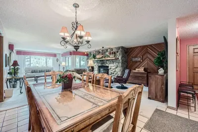 a dining room and kitchen with a large table and chairs at 122 Cinnamon Ridge condo in Keystone