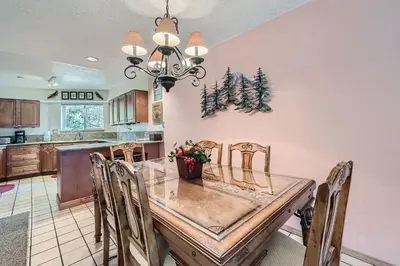 a dining room with a glass table and chairs at 122 Cinnamon Ridge condo in Keystone