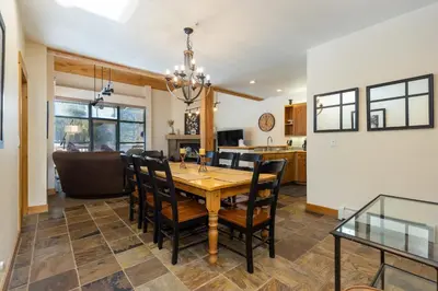 a dining room and kitchen with a table and chairs at 8721 Ski Tip Townhomes townhouse in Keystone