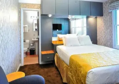 a hotel room with a large bed and a bathroom at Diamond - The Historic Crags Lodge - ST in Estes Park
