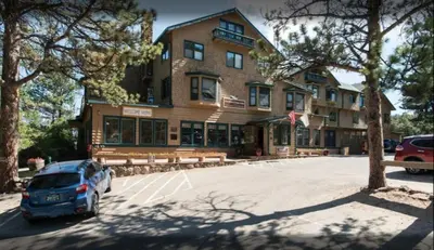 a car parked in a parking lot in front of a building at Diamond - The Historic Crags Lodge - ST in Estes Park