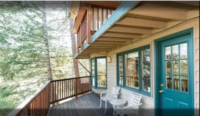 a porch with two chairs and a blue door at Diamond - The Historic Crags Lodge - ST in Estes Park