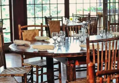 a dining room with a wooden table and chairs at Diamond - The Historic Crags Lodge - ST in Estes Park