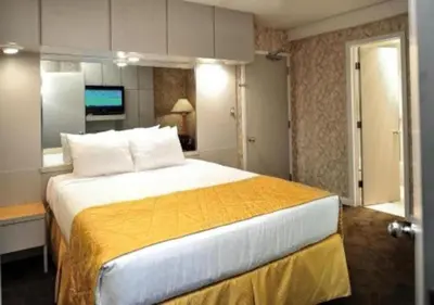 a bedroom with a large bed with a yellow blanket at Diamond - The Historic Crags Lodge - 1BD in Estes Park