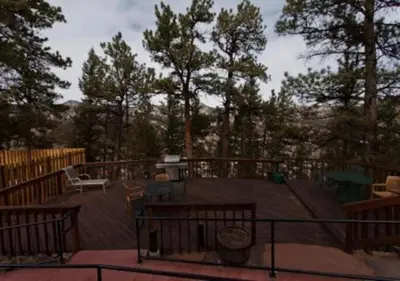 a deck with a table and a bench on a deck at Diamond - The Historic Crags Lodge - 1BD in Estes Park