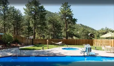 a backyard with a swimming pool with a swing at Diamond - The Historic Crags Lodge - 1BD in Estes Park