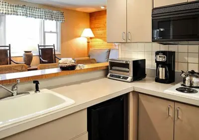 a kitchen with a sink and a microwave at Diamond - The Historic Crags Lodge - 2BD in Estes Park