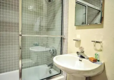 a bathroom with a sink and a shower and a tub at Diamond - The Historic Crags Lodge - 2BD in Estes Park