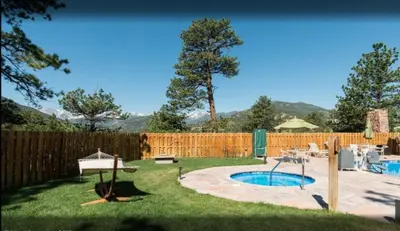 a backyard with a swimming pool and a fence at Diamond - The Historic Crags Lodge - 2BD in Estes Park