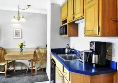 a kitchen with a sink and a kitchen with a table at Diamond - The Historic Crags Lodge - 2BD in Estes Park