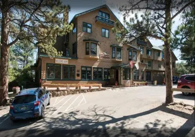a car parked in a parking lot in front of a building at Diamond - The Historic Crags Lodge - 2BD in Estes Park