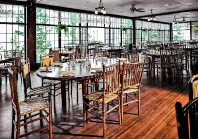 a dining room with tables and chairs and windows at Diamond - The Historic Crags Lodge - 2BD in Estes Park