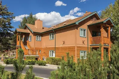 a large wooden house with a balcony at Worldmark - Estes Park 1BD in Estes Park