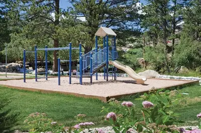 a playground with a slide in a park at Worldmark - Estes Park 1BD in Estes Park