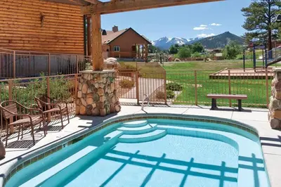 a swimming pool on a patio with a house at Worldmark - Estes Park 1BD in Estes Park