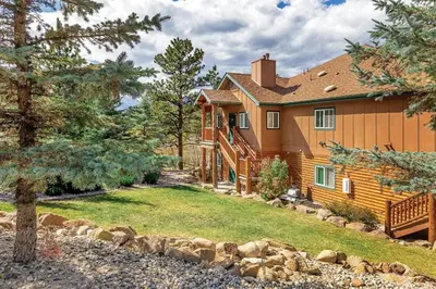 a large wooden house with a yard at Worldmark - Estes Park 1BD in Estes Park