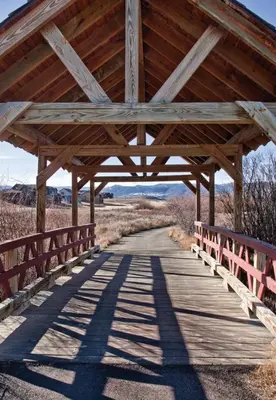 a wooden bridge with a wooden roof over a road at Worldmark Granby Rocky Mountain 1BD in Granby