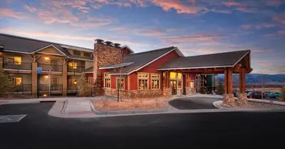a large building with a parking lot in front of it at Worldmark Granby Rocky Mountain 1BD in Granby