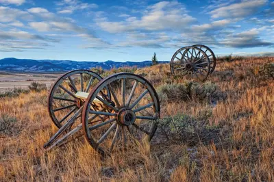 two old wooden wheels sitting in a field at Worldmark Granby Rocky Mountain 1BD in Granby