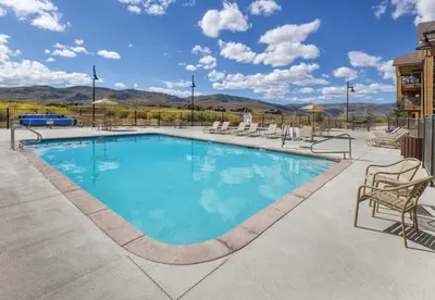 a large swimming pool with chairs at Worldmark Granby Rocky Mountain 2BD in Granby
