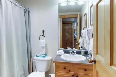 a bathroom with a toilet and a sink and a shower at Tenderfoot Lodge 2 Bedroom At The Mountain House Base in Keystone