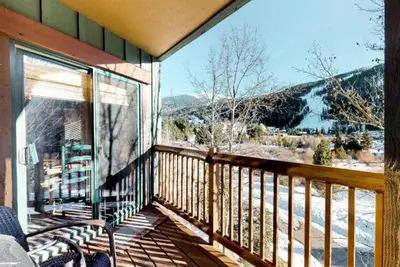 a balcony with a view of a snow covered mountain at Tenderfoot Lodge 2 Bedroom At The Mountain House Base in Keystone