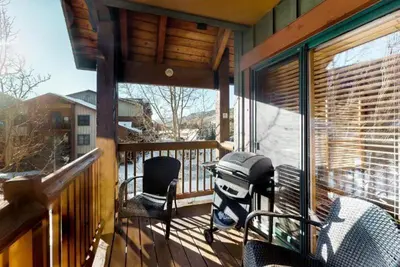 a screened in porch with chairs and a table at Tenderfoot Lodge 2 Bedroom At The Mountain House Base in Keystone