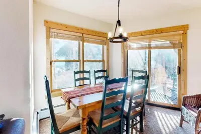 a dining room with a wooden table and chairs at Tenderfoot Lodge 2 Bedroom At The Mountain House Base in Keystone