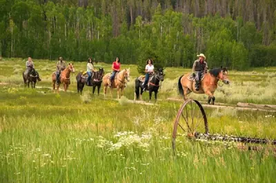 a group of people riding horses in a field at Tenderfoot Lodge 1 Bedroom At The Mountain House Base in Keystone
