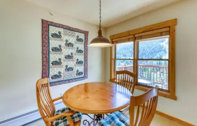 a dining room with a wooden table and chairs at Tenderfoot Lodge 1 Bedroom At The Mountain House Base in Keystone