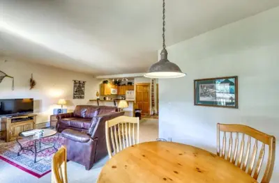 a living room with a table and a couch at Tenderfoot Lodge 1 Bedroom At The Mountain House Base in Keystone