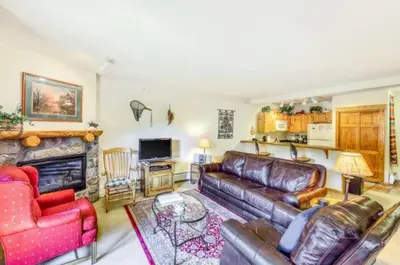 a living room with leather furniture and a fireplace at Tenderfoot Lodge 1 Bedroom At The Mountain House Base in Keystone
