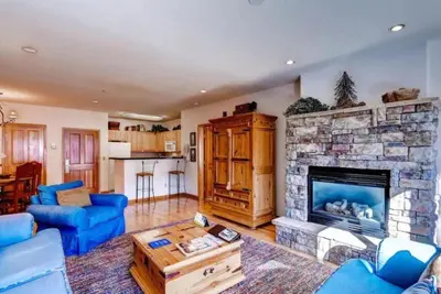 a living room with a couch and a fireplace at 2 Bedroom Gateway Lodge Condo Near Mountain House in Keystone