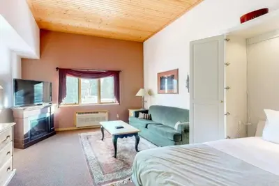 a bedroom with a bed and a couch and a tv at Studio Condo At Gateway Lodge In Keystone in Keystone