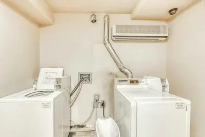 a laundry room with two machines and a air conditioner at Studio Condo At Gateway Lodge In Keystone in Keystone