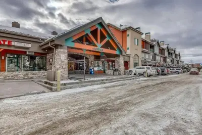 a street with cars parked in front of a building at Studio Condo At Gateway Lodge In Keystone in Keystone