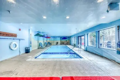 a swimming pool in a large room with blue walls at Studio Condo At Gateway Lodge In Keystone in Keystone