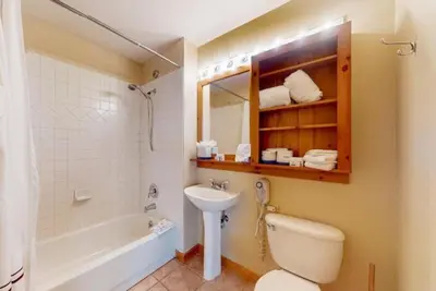 a bathroom with a sink and a toilet and a tub at Dakota Lodge 2 Bedroom Condo In River Run Village in Keystone