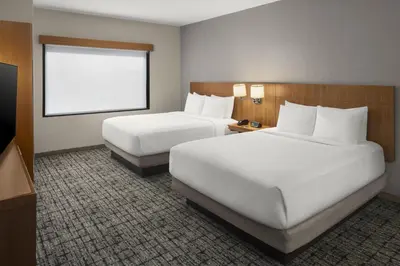 a hotel room with two beds and a window at Hyatt Place Denver Cherry Creek in Denver