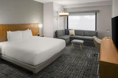 a hotel room with a bed and a couch at Hyatt Place Denver Cherry Creek in Denver