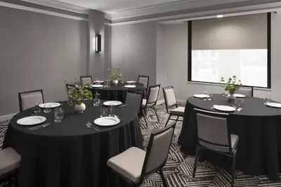 a conference room with tables and chairs and a window at Hyatt Place Denver Cherry Creek in Denver