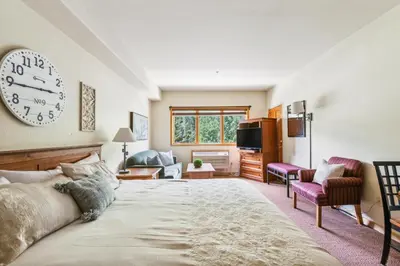 a bedroom with a large clock on the wall at Cozy Ski-In Ski-Out Condo with Heated Pool in Keystone